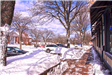 View of snow on and around sidewalks in front of downtown businesses