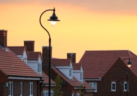 Row of townhouses with street lamp at sundown